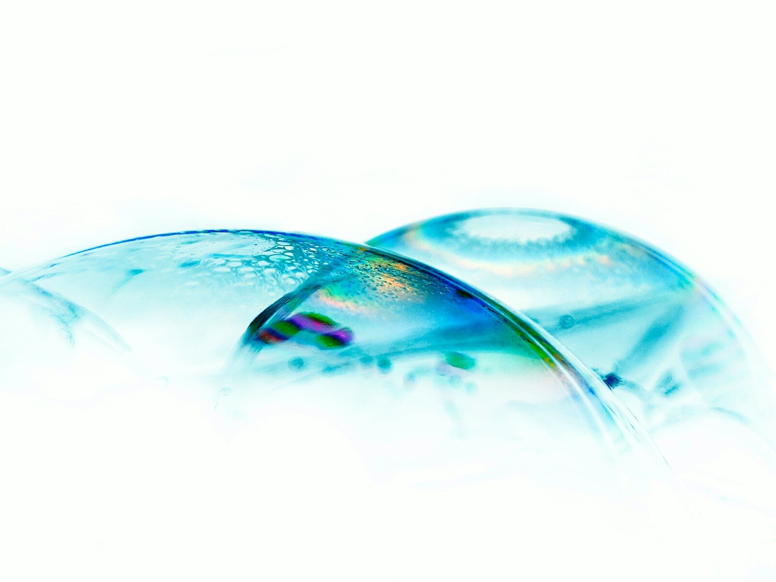 a close up of two glass objects on a white surface